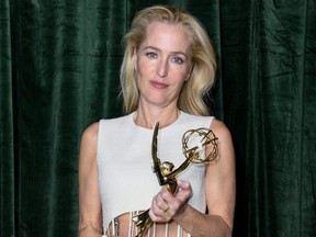 Gillian Anderson poses with her Emmy Award for 'Outstanding Supporting Actress for a Drama Series' during the 73rd Primetime Emmys Celebration at Soho House in London, England, Sept. 19, 2021.