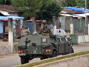Members of the Armed Forces of Guinea drive through the central neighbourhood of Kaloum in Conakry on Sept. 5, 2021 after sustainable gunfire was heard.