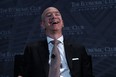 Jeff Bezos laughs as he participates in a discussion during a Milestone Celebration dinner September 13, 2018 in Washington, DC.