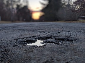 Sunsetting over a pothole on the street.