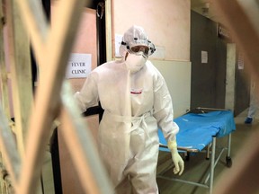 Health officials in full protective gear walk inside an isolation ward of Ernakulam Medical College in Kochi in the Indian southwestern state of Kerala on June 6, 2019.