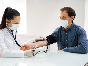 A doctor checks blood pressure.