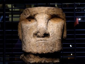 A Moai head from Easter Island is seen on Sept. 28, 2020 at the Paris' Quai Branly museum. The Olmecs were the earliest known major Mesoamerican civilization, and this Olmec head (1200-900 BC), weighs five tons.