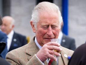 Britain's Prince Charles, Prince of Wales has a dram of whisky before officially opening the Lerwick Fishmarket, Mair's Quay and the Scalloway Fish Market, at Shetland Seafood Auctions Ltd, Lerwick Fishmarket in Lerwick, Shetland on July 30, 2021, the second day of a two-day visit to Scotland.