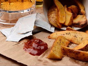 French Fries With Ketchup on Brown Bag And Beer
