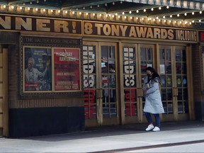 A pedestrian walks past the closed Broadway show Hadestown on April 2, 2020 in New York City.