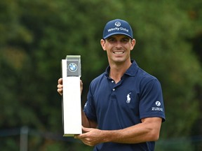U.S. golfer Billy Horschel poses with the trophy after his victory in the PGA Championship at Wentworth Golf Club in Surrey, south west of London on Sept. 12, 2021.
