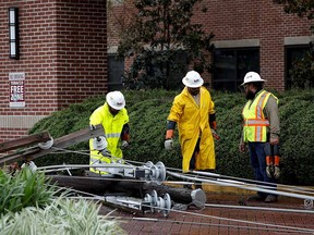 Power restoration workers inspect the area surrounding an affected hospital after Hurricane Ida made landfall in Houma, Louisiana, September 1, 2021.