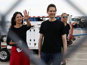 Former diplomat Michael Kovrig and his wife Vina Nadjibulla react following his arrival on a Canadian air force jet after his release from detention in China, at Pearson International Airport in Toronto, Sept. 25, 2021.