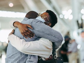 African couple reuniting at airport arrivals