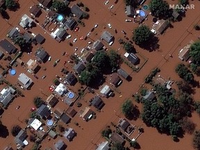 A satellite image shows houses along Boesel Avenue submerged in flood water in Manville, N.J.