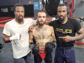 Jack Hemmings is flanked by Double Trouble — Chad Thonson (right) and twin brother Trevor Thonson — all of whom will be fighting in Atlanta on Sunday.