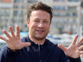 British chef and activist Jamie Oliver poses during a photocall for TV series "Jamie Oliver" as part of the MIPCOM, the world's biggest television and entertainment market, on Oct. 8, 2018 in Cannes, southeastern France.