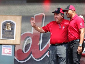 Cincinnati Reds Hall of Famers Johnny Bench (left) and Barry Larkin (right) stand next to the Hall of Fame plaque of Reds' Joe Morgan at Great American Ball Park.