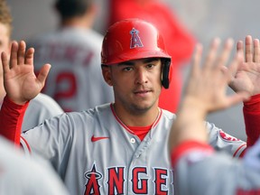 Jose Iglesias of the Los Angeles Angels celebrates in the dugout after scoring during the eighth inning against the Cleveland Indians at Progressive Field on Aug. 21, 2021 in Cleveland, Ohio.