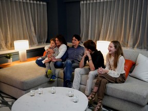 Canada's Liberal Prime Minister Justin Trudeau, accompanied by his wife Sophie Gregoire and his children Ella-Grace, Xavier and Hadrien watch the election coverage on a TV, in Montreal on Monday, Sept. 20, 2021.
