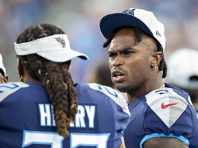 Julio Jones (right) talks on the sidelines with Derrick Henry of the Tennessee Titans during an NFL preseason game against the Chicago Bears at Nissan Stadium on August 28, 2021 in Nashville.