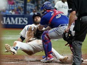 Toronto Blue Jays catcher Alejandro Kirk (30) tags out Tampa Bay Rays' Kevin Kiermaier trying to score during the sixth inning of a baseball game Monday, Sept. 20, 2021, in St. Petersburg, Fla. (AP Photo/Chris O'Meara)