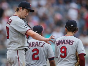 Minnesota Twins starting pitcher Kenta Maeda (18) looks at his arm following a conference on the mound against the New York Yankees at Yankee Stadium.