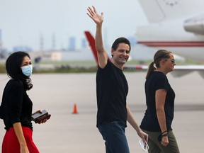 Former diplomat Michael Kovrig, his wife Vina Nadjibulla and sister Ariana Botha walk following his arrival on a Canadian air force jet after his release from detention in China, at Pearson International Airport in Toronto September 25, 2021.