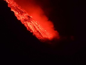 Lava flows into the sea, as seen from Tijarafe, following the eruption of a volcano on the Canary Island of La Palma, Spain, Sept. 29, 2021.