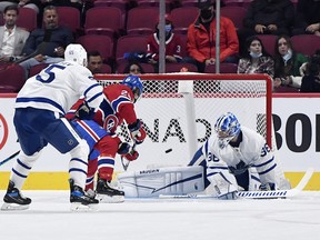 Canadiens' Christian Dvorak scores a goal against Maple Leafs goalie Jack Campbell during the first period at the Bell Centre on Monday, Sept. 27, 2021.