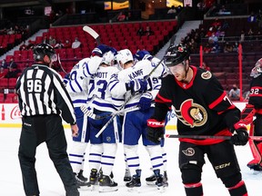 Maple Leafs players celebrate a goal by Leafs centre David Kampf as Senators centre Chris Tierney skates away during first period pre-season action in Ottawa on Wednesday, Sept. 29, 2021.