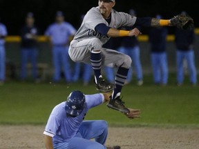 London Majors second baseman Chris McQueen turns a double play on Toronto Maple Leafs Justin Marra at Game 4 of the Intercounty Baseball championship at Christie Pits on Thursday The Leafs went on to win 6-5 in extras. Jack Boland/Toronto Sun
