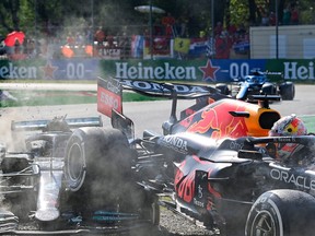 Red Bull's Dutch driver Max Verstappen, right, and Mercedes' British driver Lewis Hamilton collide during the Italian Formula One Grand Prix at the Autodromo Nazionale circuit in Monza, on Sept. 12, 2021.