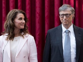 Philanthropist and co-founder of Microsoft, Bill Gates and his wife Melinda listen to the speech by French President Francois Hollande, prior to being awarded Commanders of the Legion of Honor at the Elysee Palace in Paris