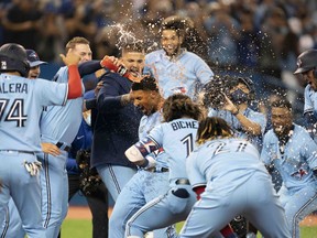 Toronto Blue Jays shortstop Marcus Semien celebrates with the team after hitting a walkoff home run during the ninth inning against the Oakland Athletics at Rogers Centre in Toronto, Sept. 3, 2021.