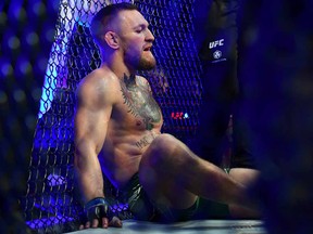 Conor McGregor reacts following an injury suffered against Dustin Poirier during UFC 264 at T-Mobile Arena.