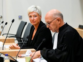 Relative of victims, Ria van der Steen and lawyer August Van are seen in the courtroom where the MH17 trial of three Russians and a Ukrainian is taking place as it enters a new stage where families of victims of the MH17 plane crash give testimony in Badhoevedorp, Netherlands, Sept. 6, 2021.