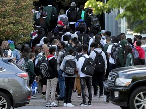 Students line up to get into St. Pat's High School in Ottawa Tuesday, Sept. 7, 2021.