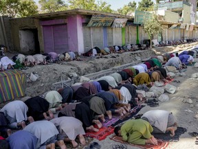 Muslim devotess offer Friday prayers along a street in Kabul on Sept. 17, 2021.