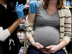 A pregnant woman receives a vaccine for COVID-19 at Skippack Pharmacy in Schwenksville, Pa., Feb. 11, 2021.