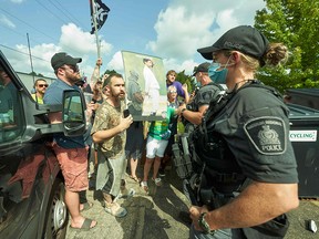 Protestors confront police during a Liberal campaign event with Prime Minister Justin Trudeau at VeriForm Inc. in Cambridge, Ontario, on August 29, 2021.