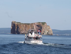 A boat leaves Ile Bonaventure near Perce, Que., with Perce Rock in the background. RUTH DEMIRDJIAN DUENCH photo