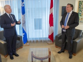Federal Conservative Leader Erin O'Toole, left, and Quebec Premier Francois Legault get set to start their meeting in Montreal, Monday, Sept. 14, 2020.