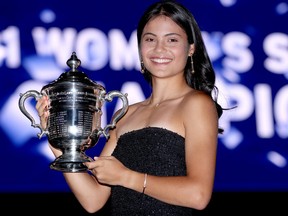 Emma Raducanu of Great Britain poses with the championship trophy after defeating Leylah Annie Fernandez of Canada during their Women's Singles final match on Day 13  of the 2021 U.S. Open at the USTA Billie Jean King National Tennis Center on Sept. 11, 2021 in the Flushing neighbourhood of the Queens borough of New York City.