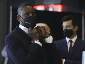 Raptors Masai Ujiri, vice-chairman and president of the team, and general manager Bobby Webster (R) stand at the back of the press conference on media day at the Scotiabank Arena.