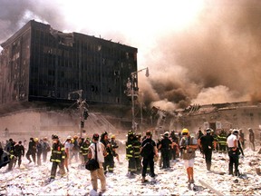 New York City firefighters and other emergency personnel battle building blaze after the World Trade Center buildings collapsed in New York, Sept. 11, 2001.