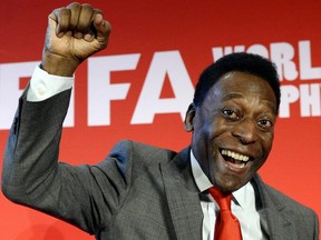 In this file photo taken March 10, 2014, Brazilian football legend Pele gestures at the end of a press conference as part of France's stage of the World Cup trophy world tour, in Paris.