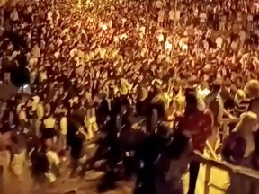 People take part in an illegal "macro-botellon" drinking party amid the COVID-19 pandemic, in the area around Complutense University in Madrid, Spain, Sept. 17, 2021 in this still image obtained from a social media video.