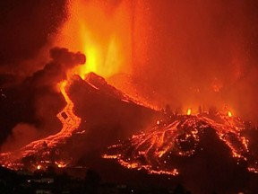 Lava pours out of a volcano in the Cumbre Vieja national park at El Paso, on the Canary Island of La Palma, September 19, 2021, in this screen grab taken from a video. FORTA/Handout via REUTERS