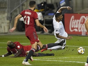 Toronto FC defender Chris Mavinga (23) takes down Inter Miami CF defender Christian Makoun (4) resulting in a penalty kick in extra time at BMO Field on Sept. 14, 2021.