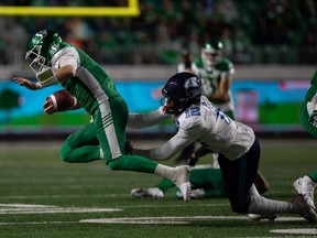 Saskatchewan Roughriders quarterback Cody Fajardo (left) is tackled by Toronto Argonauts defensive back Jamal Peters during a CFL football game at Mosaic Stadium in Regina, Sask. on Sept. 17, 2021.