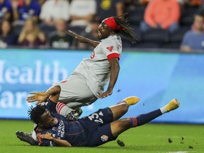 FC Cincinnati forward Isaac Atanga (23) slide tackles Toronto FC forward Ifunanyachi Achara (99) in the first half at TQL Stadium on Sept. 11, 2021.