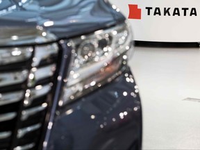 In this file photo the logo of the Japanese auto parts maker Takata is seen next to a car at a showroom in Tokyo on June 23, 2017.