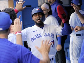 Blue Jays right fielder Teoscar Hernandez (centre) celebrates scoring during the first inning against the Minnesota Twins at Rogers Centre on Sunday.